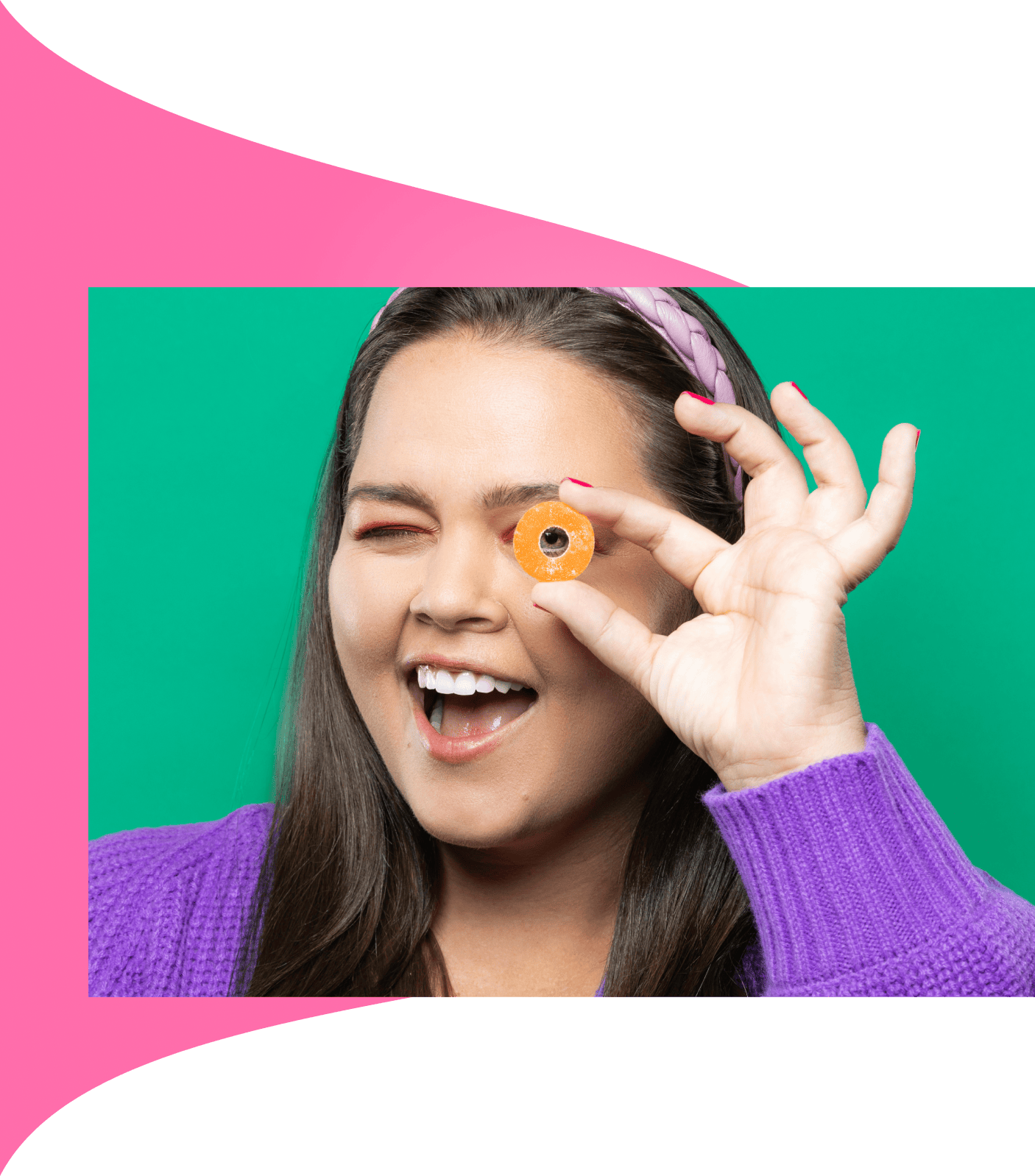 Woman holding Peach Ring to eye