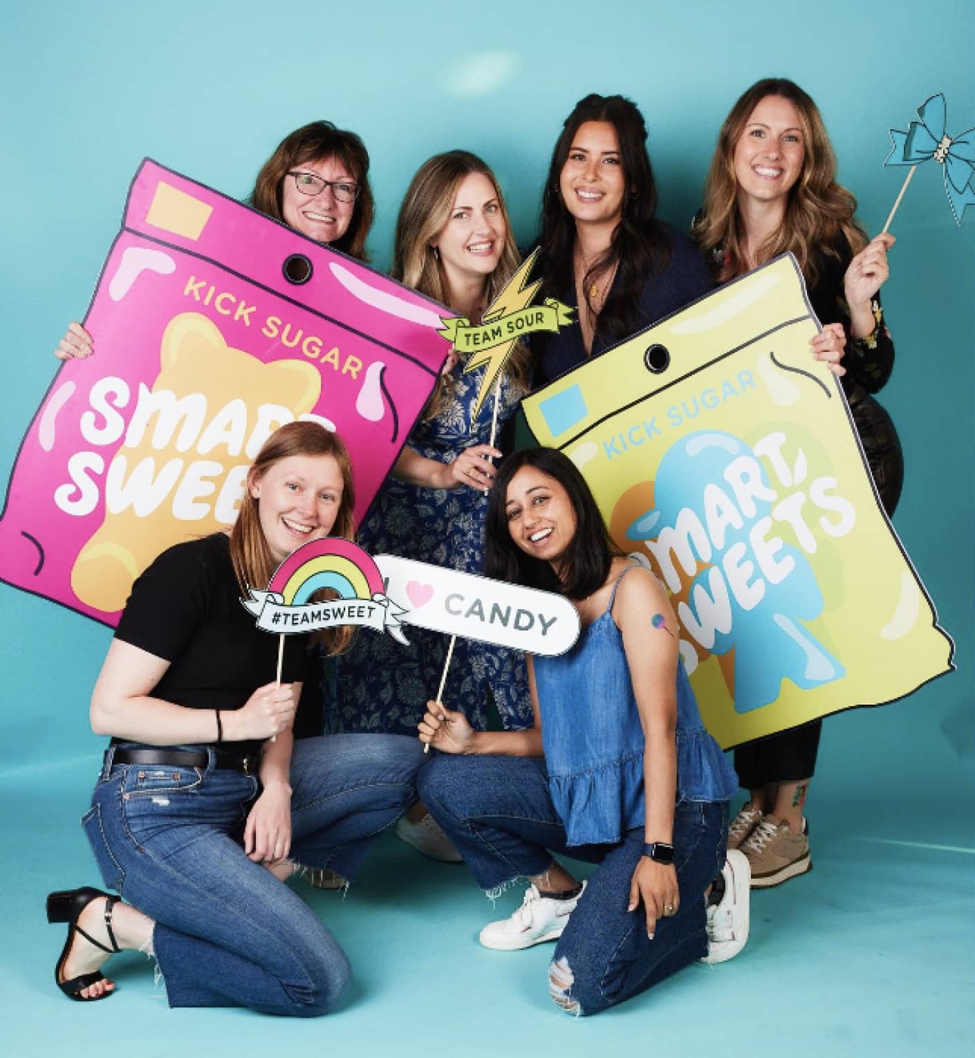 SmartSweets team group photo with cardboard cut outs of SmartSweets pouches