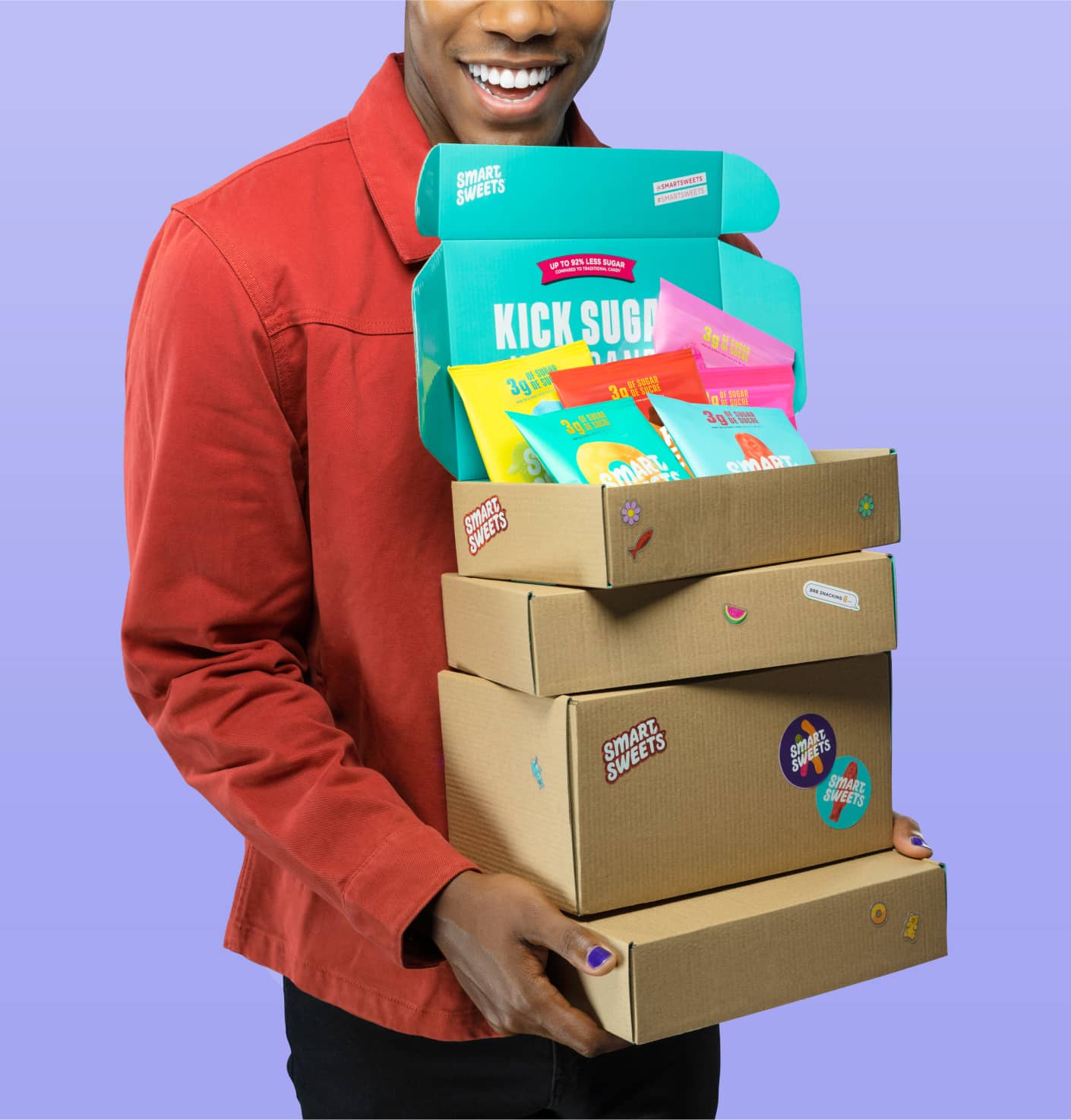 Man holding cardboard boxes with SmartSweets stickers on them
