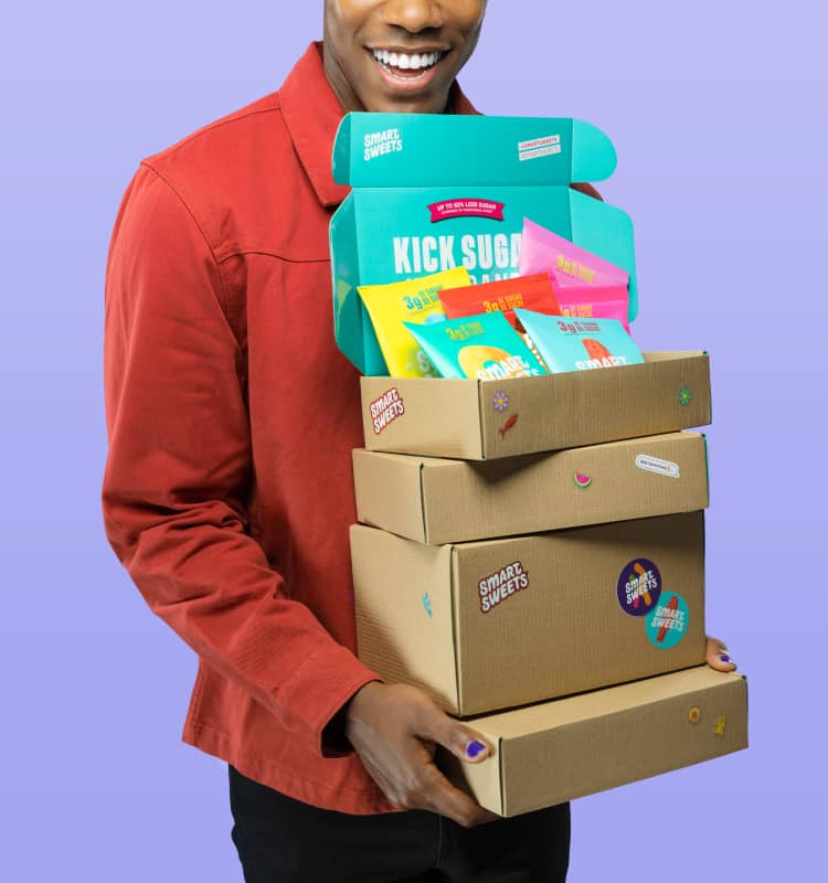 Man holding cardboard boxes with SmartSweets stickers