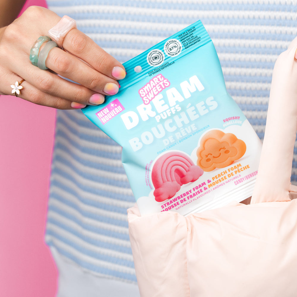 Lifestyle image. Hands holding Dream Puffs bag. 