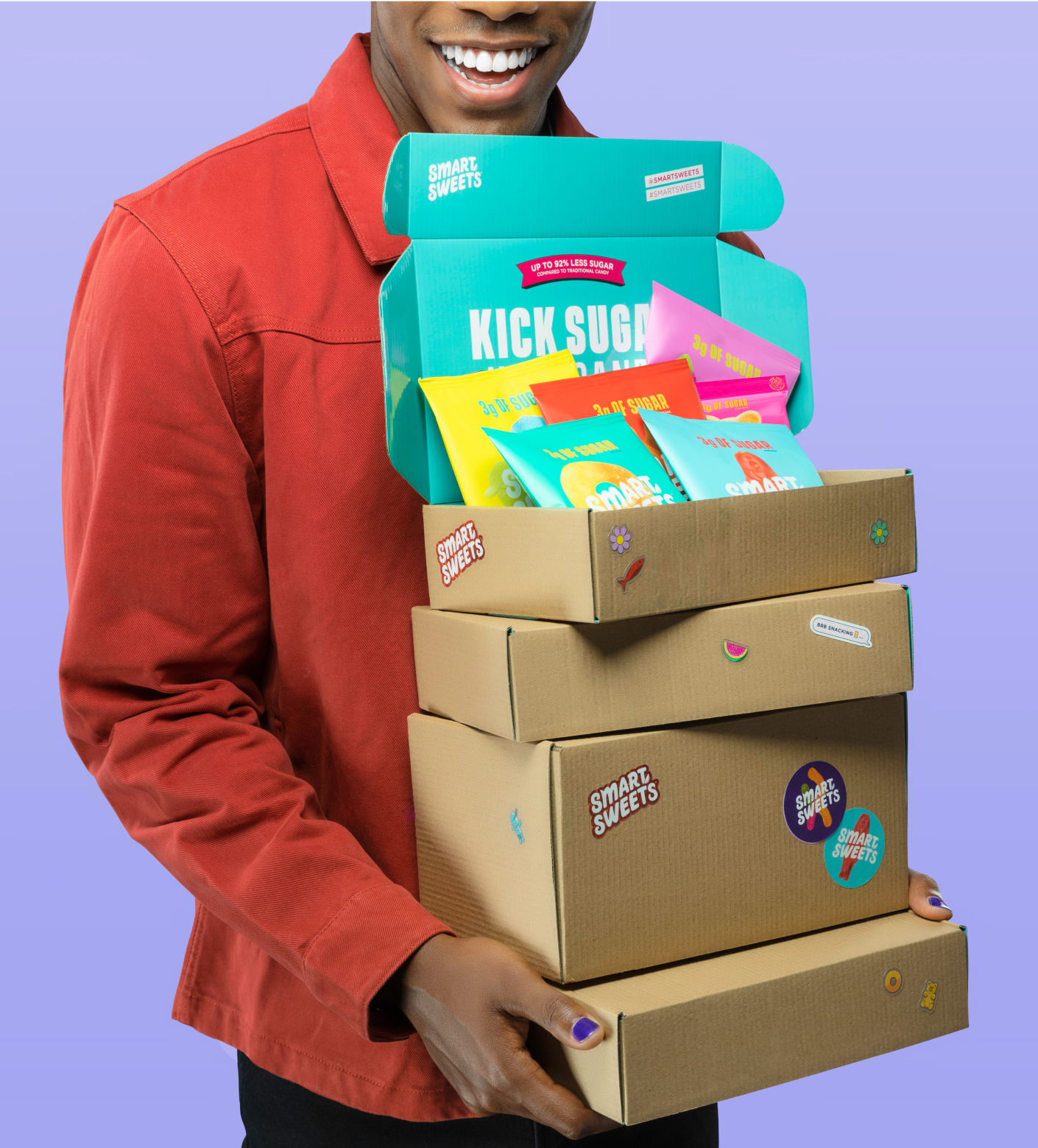 Man holding cardboard boxes with SmartSweets stickers on them